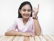 portrait of a pretty asian teenage girl showing her index finger