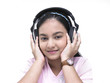 an asian teenage girl of indian origin listening to music