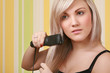 young adult woman holding straightener