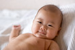 Happy baby lying on bed