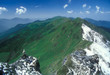 Lone trekker surveys the view in the Indian Himalaya Lone trekker surveys the view in the Indian Himalaya