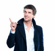 Portrait of smart young male pointing upwards isolated over whit