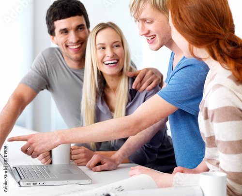 Photo: Young college student pointing at laptop Young college student pointing at laptop