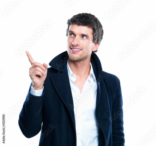 Photo : Portrait of smart young male pointing upwards isolated over whit Portrait of smart young male pointing upwards isolated over whit