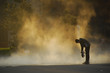 Skateboarder in mist