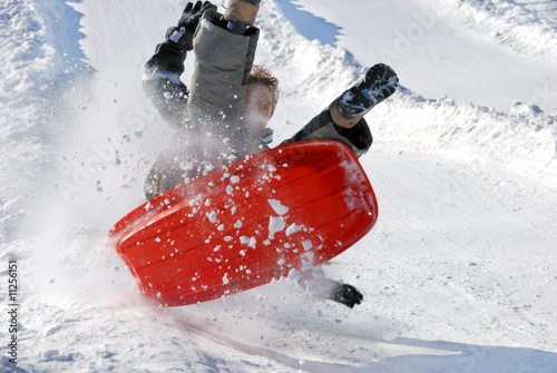 Photo: Boy in the Air with His Sled While Sledding Down the Hill Boy in the Air with His Sled While Sledding Down the Hill