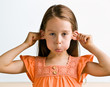Young girl pulling ears