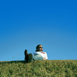 Young man is relaxing on the grass