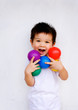Cute little boy holding up colorful balls Cute little boy holding up colorful balls