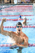 Young man cheering after winning swimming competition