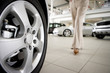 Woman walking in new car showroom