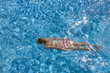 Teenage girl swimming in swimming pool