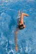 Woman swimming laps in swimming pool
