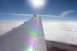 Aerial view of airplane wing and cloudy sky
