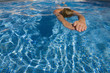Woman swimming laps in swimming pool