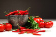 Red peppers and tomatoes with granite bowl on dark Red peppers and tomatoes with granite bowl on dark