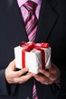 man holiday and offering a gift on his hand
