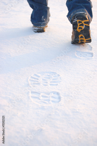 Fresh footprints from man boots on snow