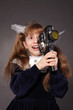 Long haired girl holding a vintage movie camera