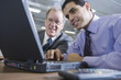 Two businessman with laptop and phone