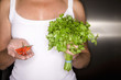 Close up of woman holding peppers and cilantro