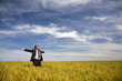businessman with his arms wide open in rural field