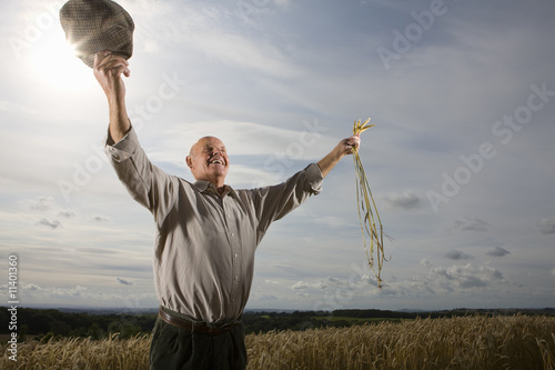 Photo: Farmer standing in field Farmer standing in field