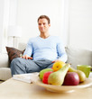 Smiling man relaxing on couch in his house