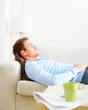 A man asleep on the living room couch