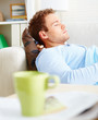 Man asleep on the couch on the living room couch