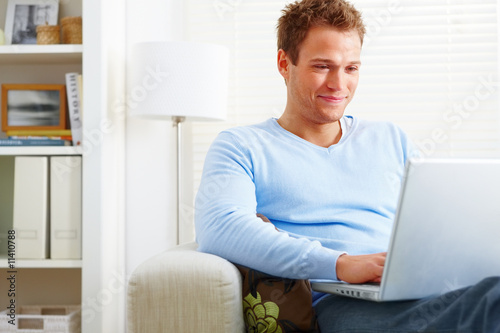 Modern Young man working on laptop at home