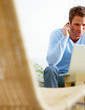 Man using a computer laptop and mobile phone