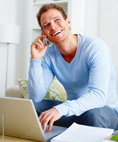 Using A Computer. Laughing man using a computer