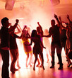 Young students dancing with joy in a disco Young students dancing with joy in a disco