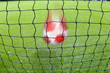 Soccer ball flying towards goal net