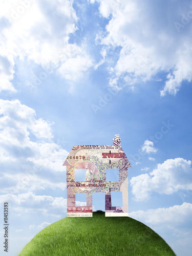 Photo: House made of British pounds on hilltop House made of British pounds on hilltop