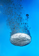 Effervescent tablet in water with bubbles
