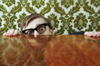 Scared nerd hiding behind a desk