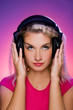 Beautiful youn female DJ in headphones