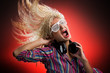 Beautiful woman with headphones dancing and screaming