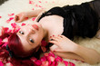 Relaxed girl in rose petals