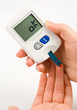 Woman with diabetes measuring blood sugar level