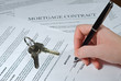 Photo: Woman signs mortgage contract Woman signs mortgage contract