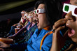 Audience in cinema wearing 3D glasses, close-up