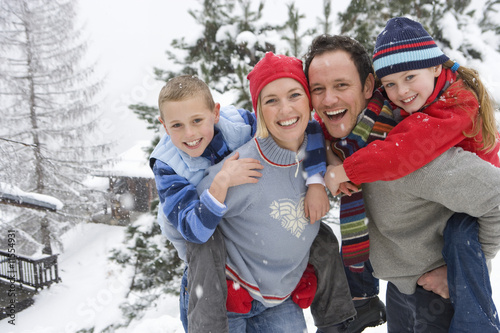 Photo: Portrait of happy family in winter setting Portrait of happy family in winter setting