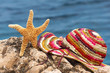Starfish and colorful hat on the beach