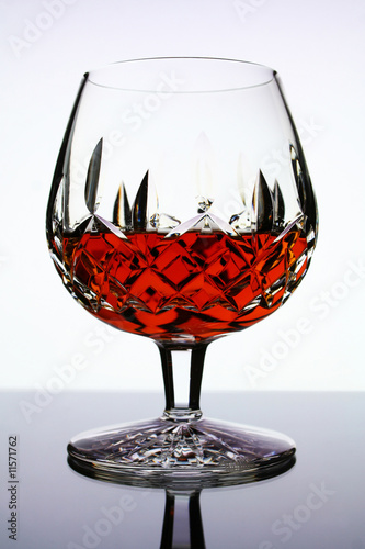 Photo: glass of cognac on white background glass of cognac on white background