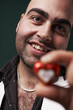 young man presenting heart in hand