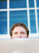 Photo en ligne au meilleur prix Businessman peering over laptop