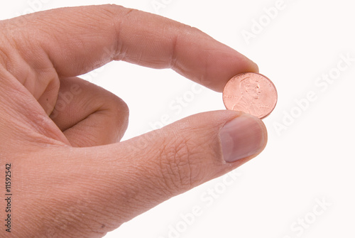 Photo: Coin held by two fingers Coin held by two fingers